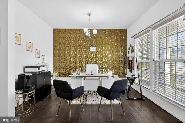 a dining room with furniture and wooden floor