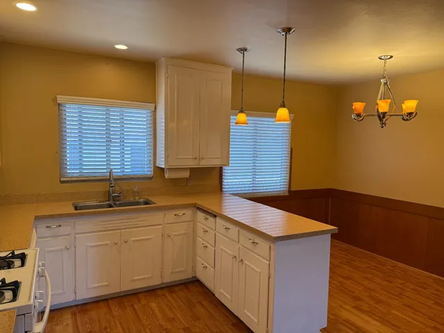 a kitchen with a sink window and cabinets