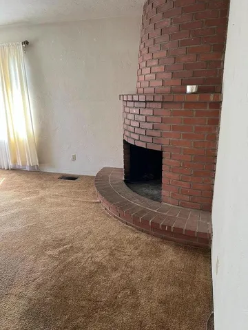 a view of empty room with fireplace