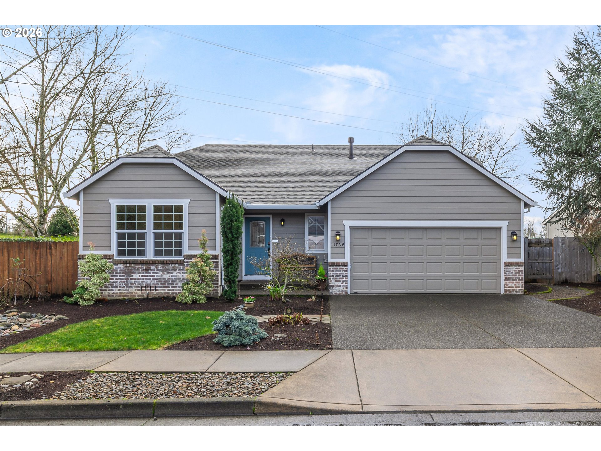 11769 Payson Lane Oregon City, OR 97045 - Photo 1 of 29 a front view of a house with a garden and yard