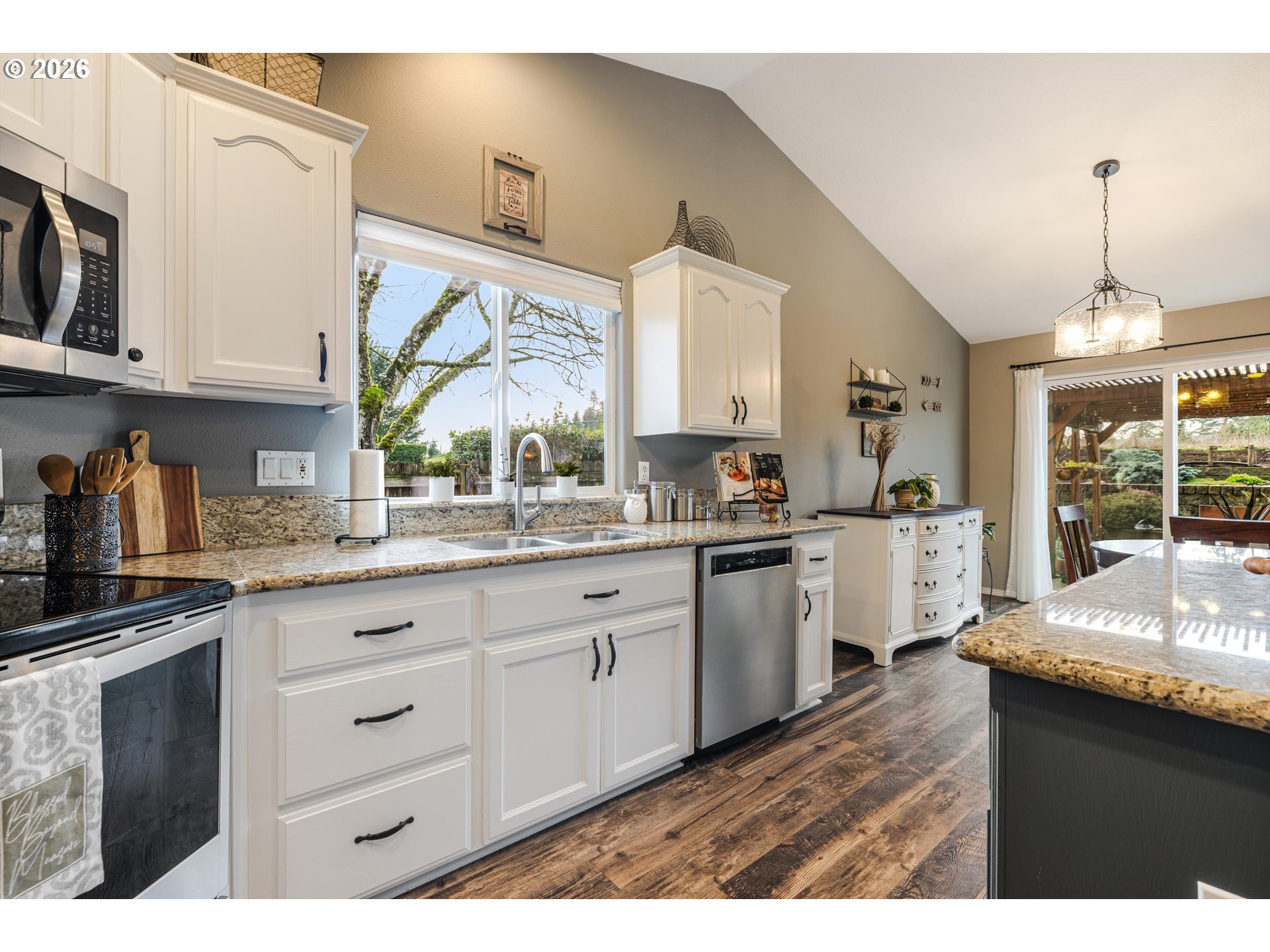 11769 Payson Lane Oregon City, OR 97045 - Photo 13 of 29 a kitchen with granite countertop a sink cabinets stainless steel appliances and a large window