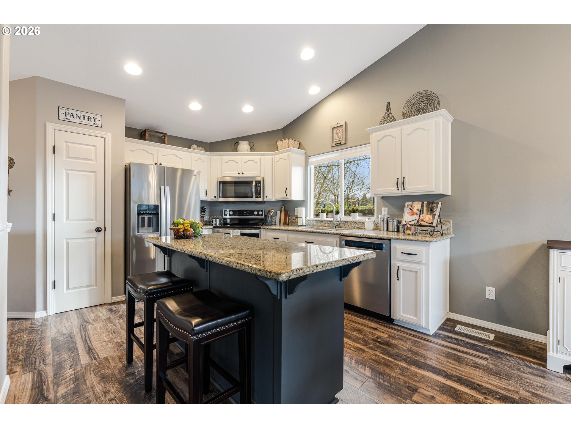 11769 Payson Lane Oregon City, OR 97045 - Photo 15 of 29 a kitchen with kitchen island granite countertop wooden cabinets and refrigerator