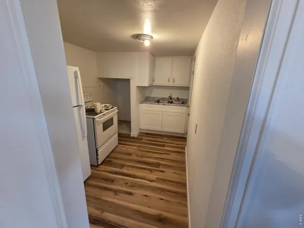 a kitchen with sink and refrigerator