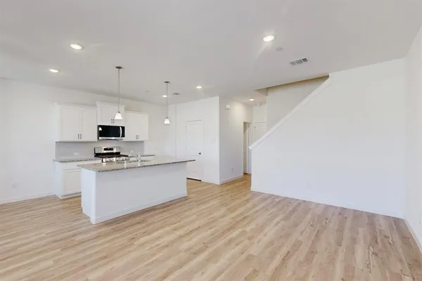 a kitchen with a sink stove and microwave