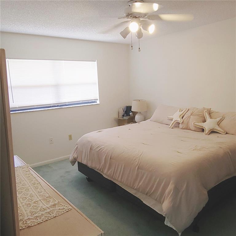 9344 Links Lane, Unit 9344 New Port Richey, FL 34655 - Photo 11 of 40 a bedroom with a bed and window