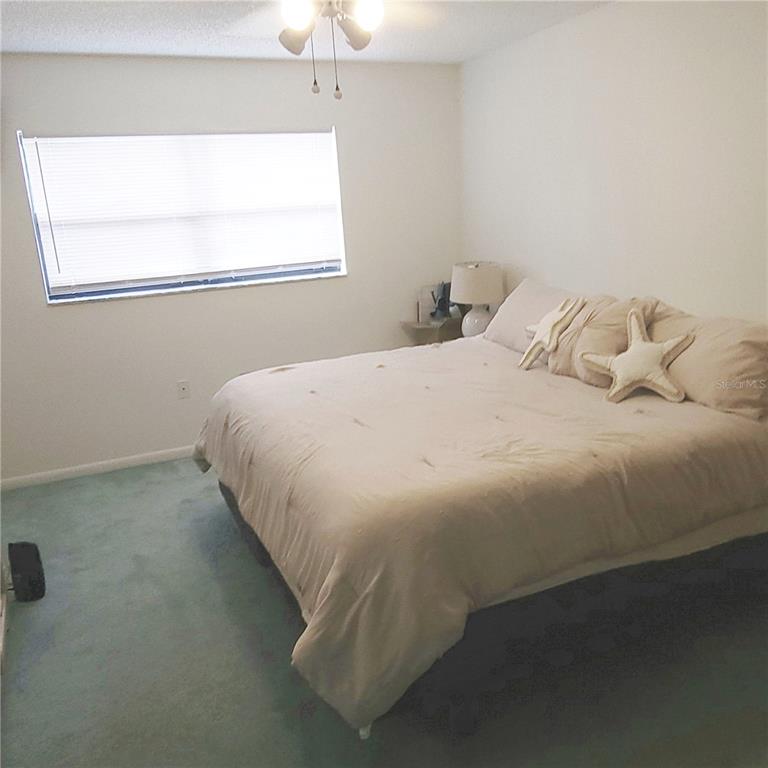 9344 Links Lane, Unit 9344 New Port Richey, FL 34655 - Photo 12 of 40 a bedroom with a bed and a window
