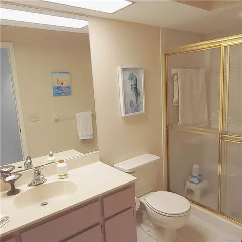 a bathroom with a sink mirror vanity and toilet