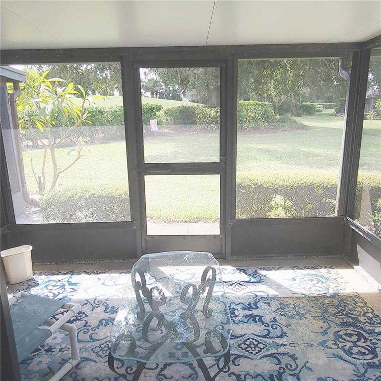 9344 Links Lane, Unit 9344 New Port Richey, FL 34655 - Photo 15 of 40 a bed sitting in a bedroom next to a window