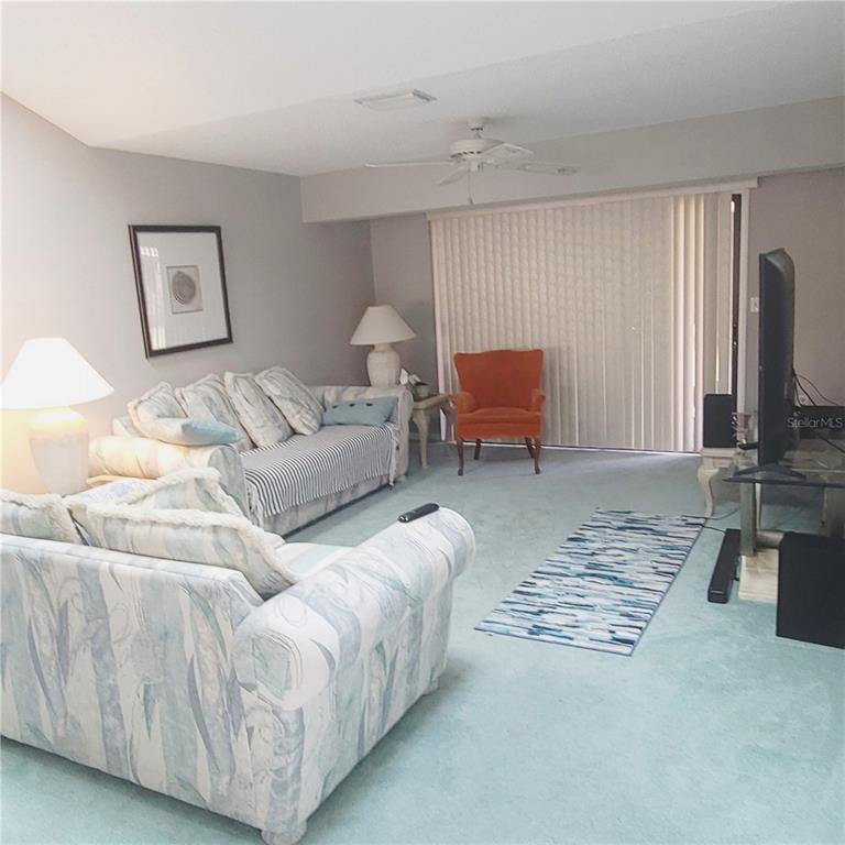 9344 Links Lane, Unit 9344 New Port Richey, FL 34655 - Photo 8 of 40 a living room with furniture and a lamp