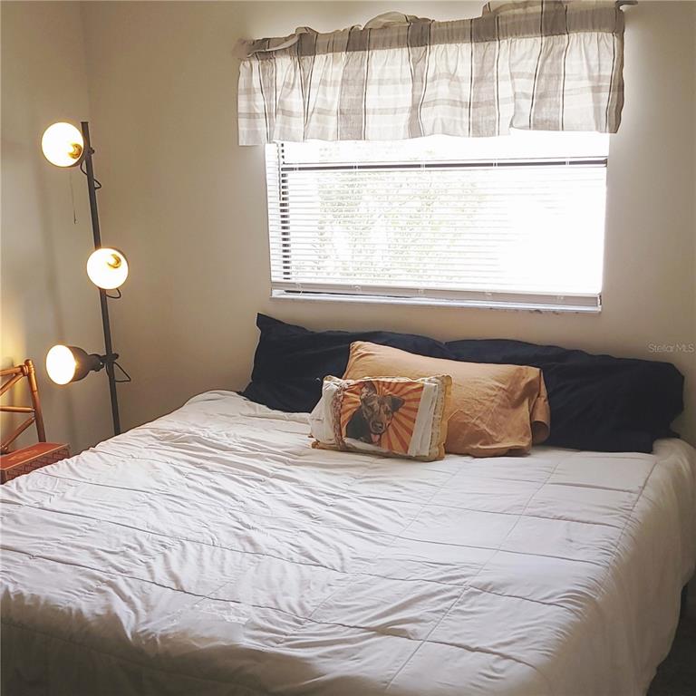 9344 Links Lane, Unit 9344 New Port Richey, FL 34655 - Photo 9 of 40 a bedroom with a bed and a window