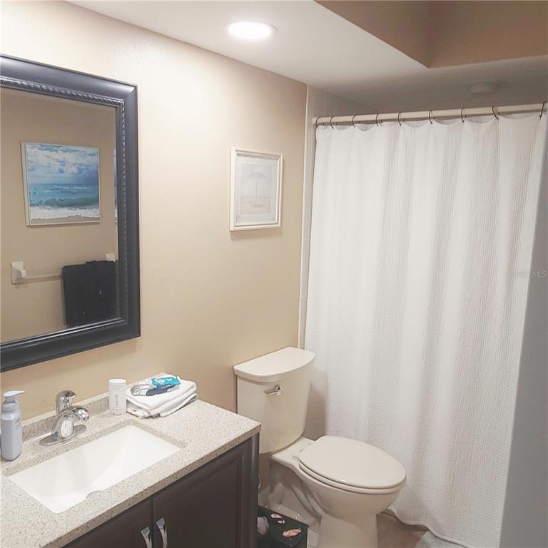 9344 Links Lane, Unit 9344 New Port Richey, FL 34655 - Photo 10 of 40 a white toilet sitting next to a bathroom sink