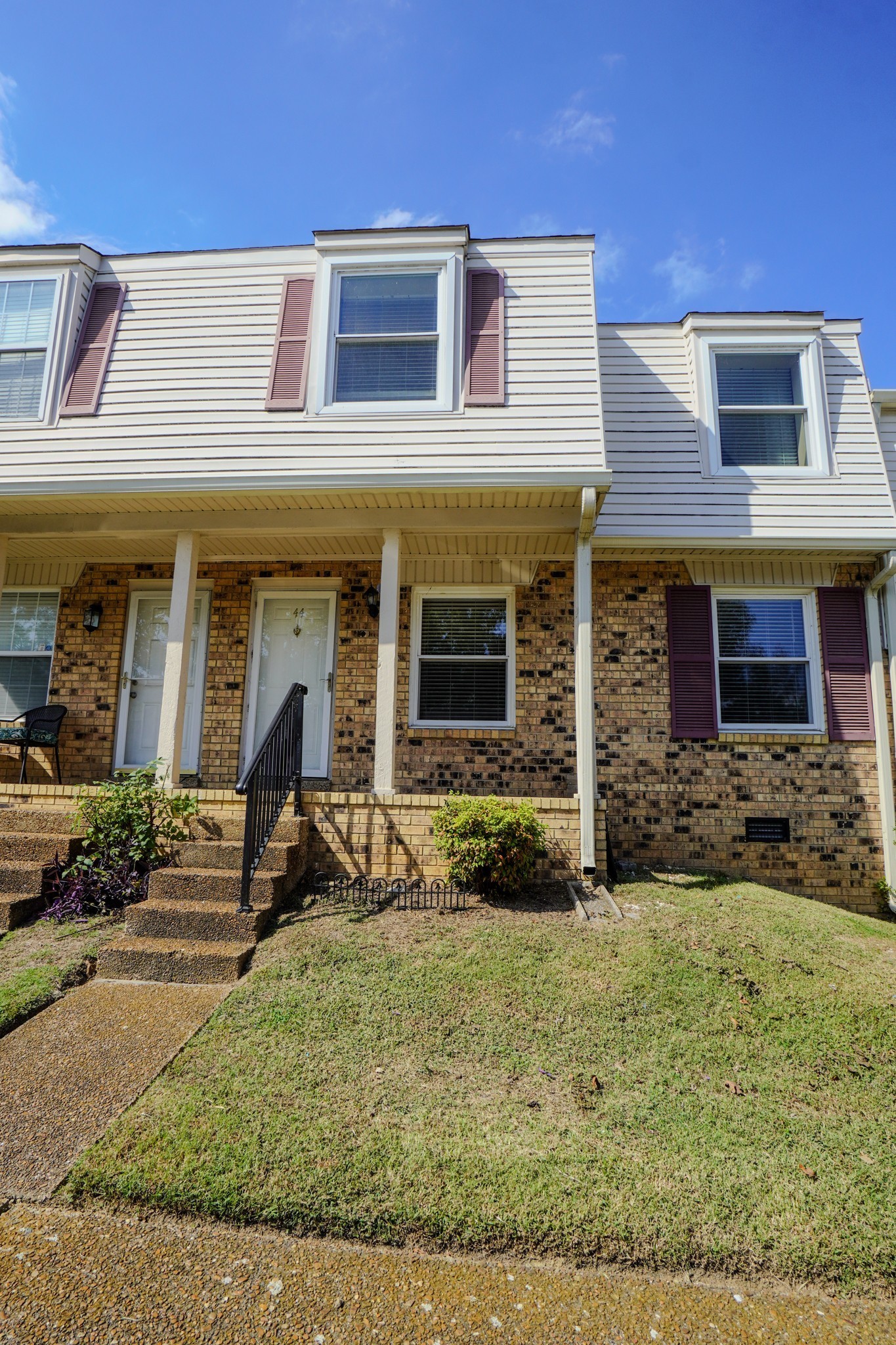 a view of a brick house with many windows