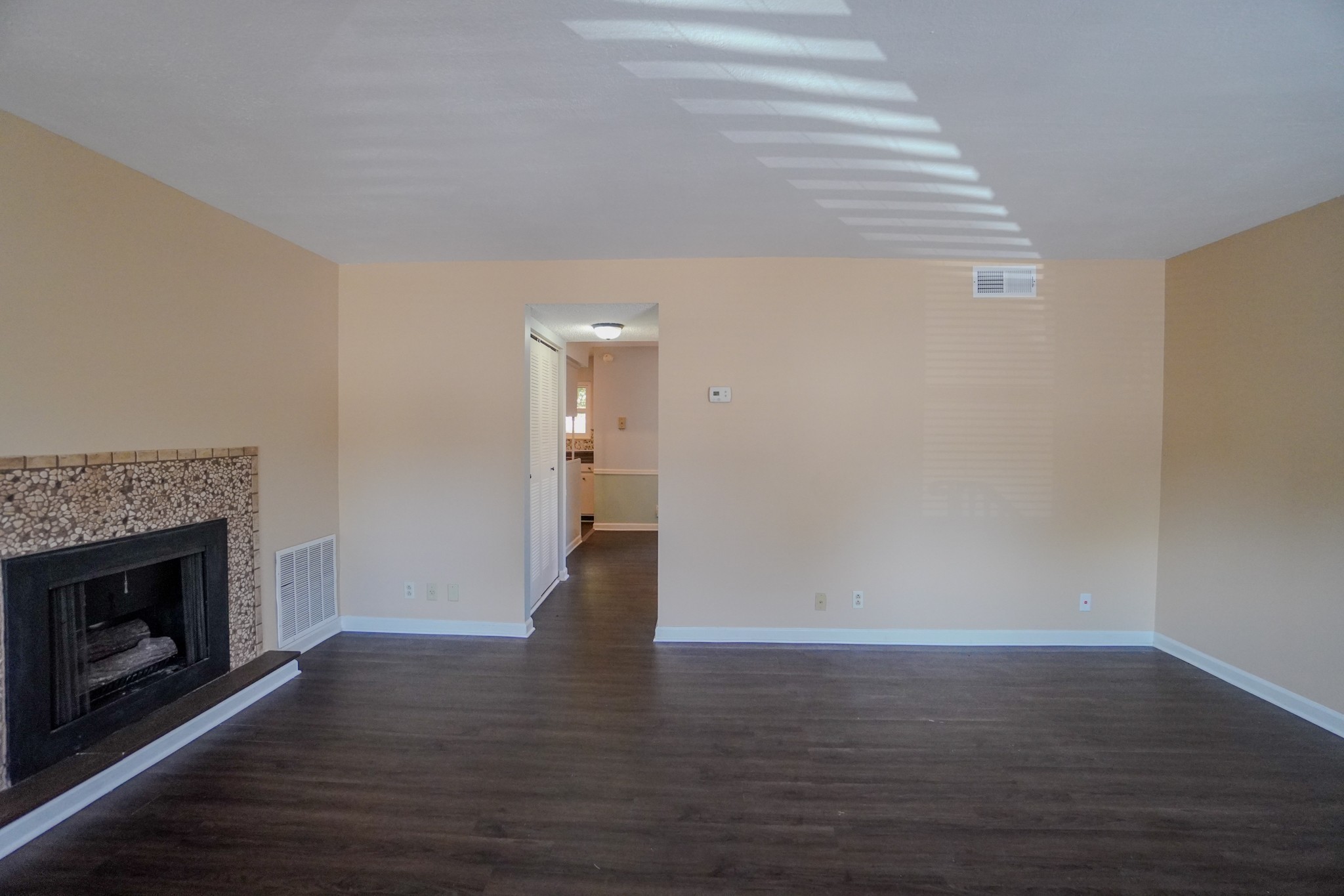 4000 Anderson Road, Unit 44 Nashville, TN 37217 - Photo 14 of 78 a view of an empty room with wooden floor fireplace and a window