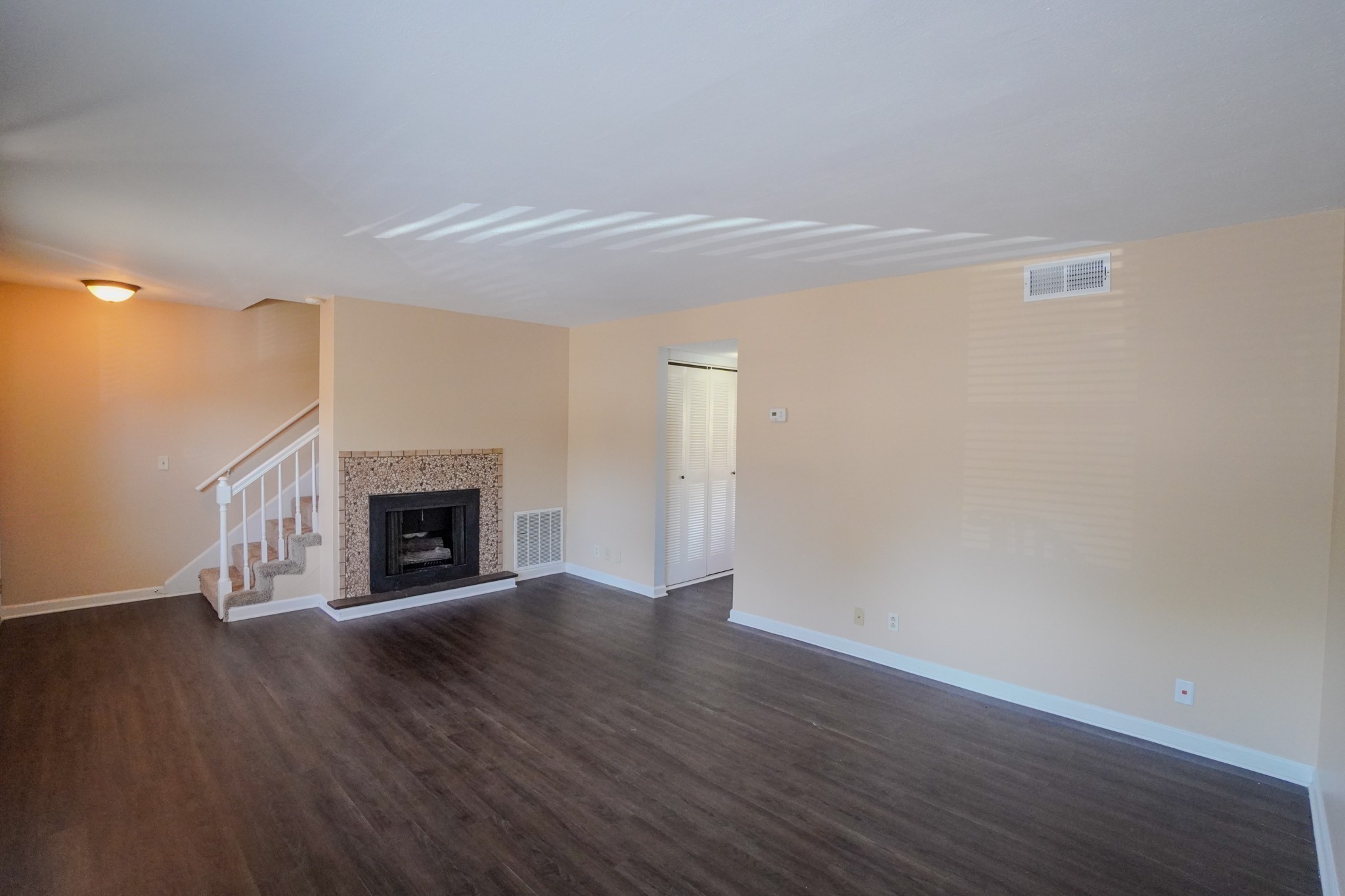 4000 Anderson Road, Unit 44 Nashville, TN 37217 - Photo 15 of 78 a view of an empty room with wooden floor fireplace and a window
