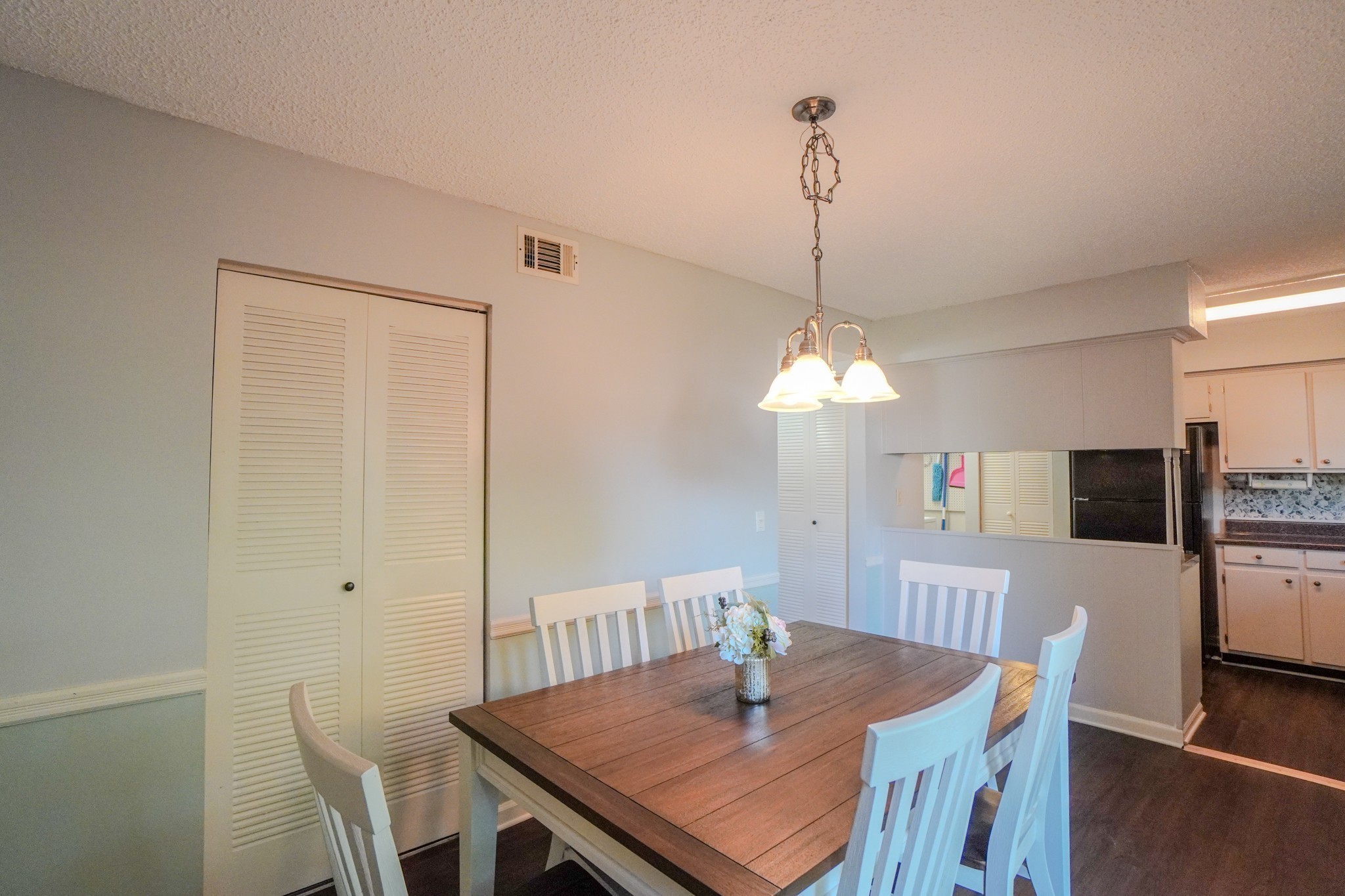 4000 Anderson Road, Unit 44 Nashville, TN 37217 - Photo 25 of 78 a view of a dining room with furniture a chandelier and wooden floor