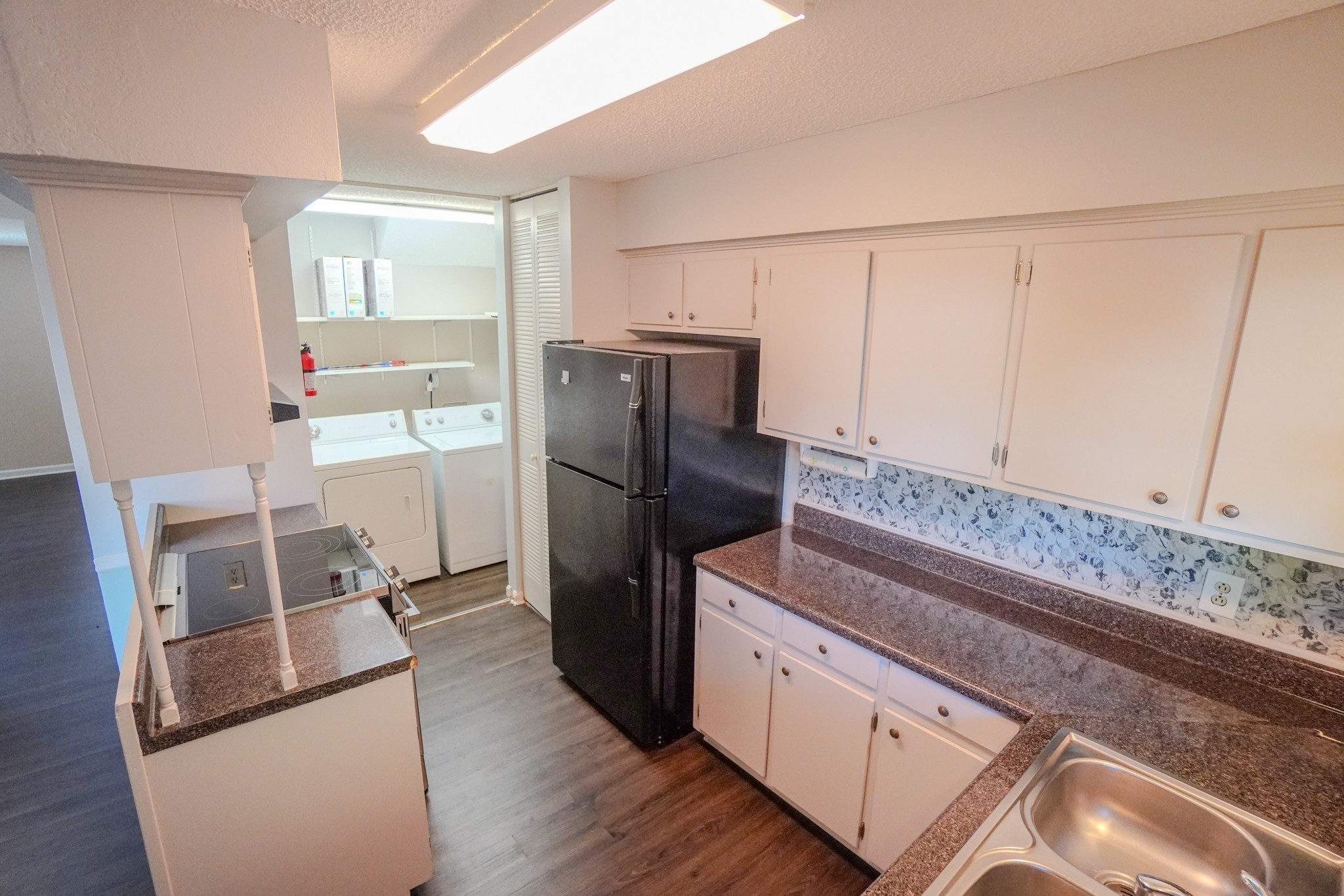 4000 Anderson Road, Unit 44 Nashville, TN 37217 - Photo 29 of 78 a kitchen with granite countertop a refrigerator and a stove top oven