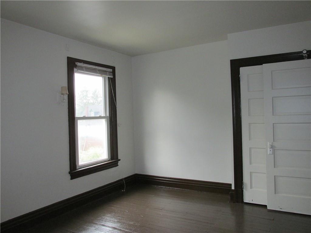 607 Gettysburg Street Pittsburgh, PA 15206 - Photo 11 of 13 an empty room with wooden floor and windows
