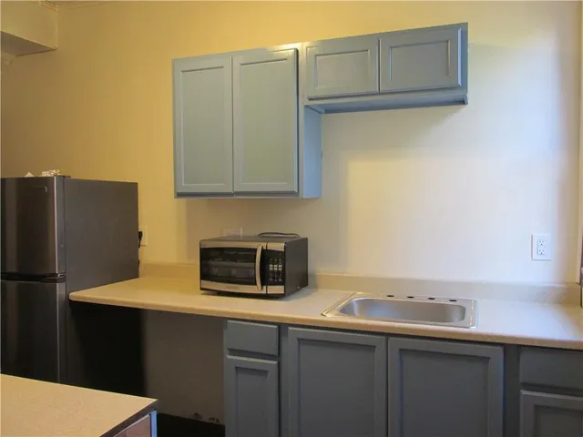 a kitchen with a sink and refrigerator