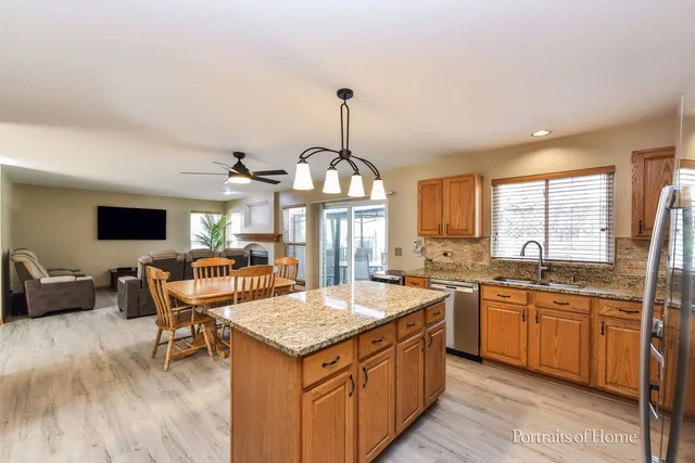 a kitchen with a stove sink and living room