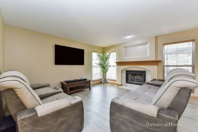 a living room with furniture a fireplace and a flat screen tv