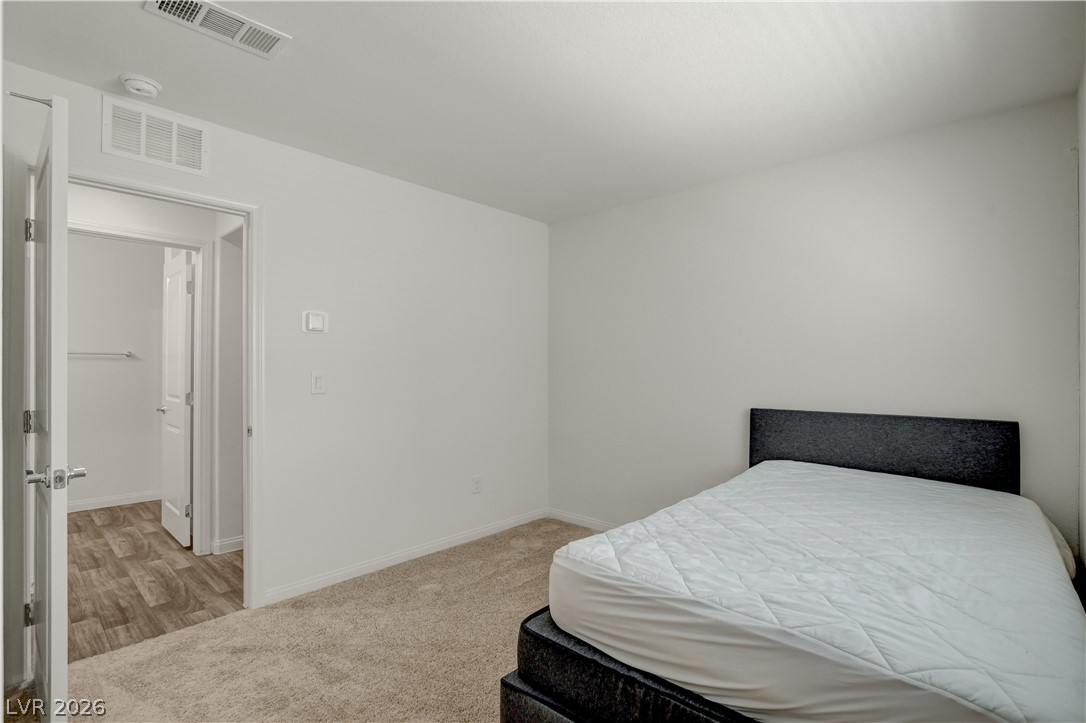 6924 Spicy Merlot Street North Las Vegas, NV 89086 - Photo 26 of 83 A well-proportioned bedroom with soft carpeting provides a peaceful personal retreat.