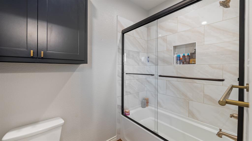 101 Lighthouse Lane Mabank, TX 75143 - Photo 25 of 40 Full bathroom with combined bath / shower with glass door and a textured wall