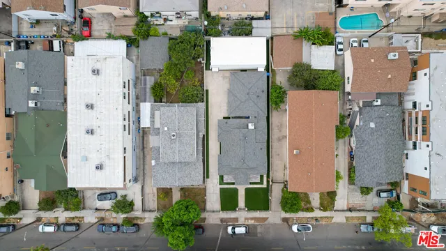 an aerial view of residential houses with city view