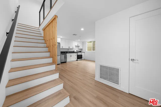 a view of kitchen and hall with wooden floor