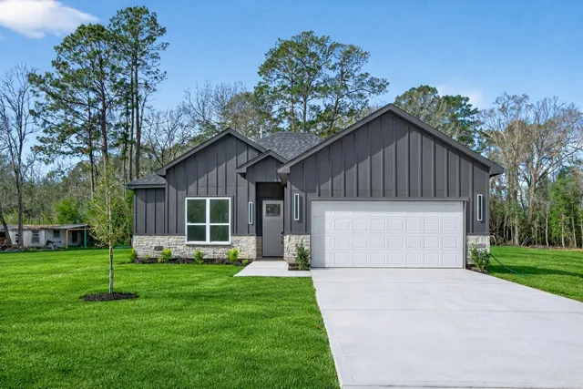 a front view of house with yard and green space