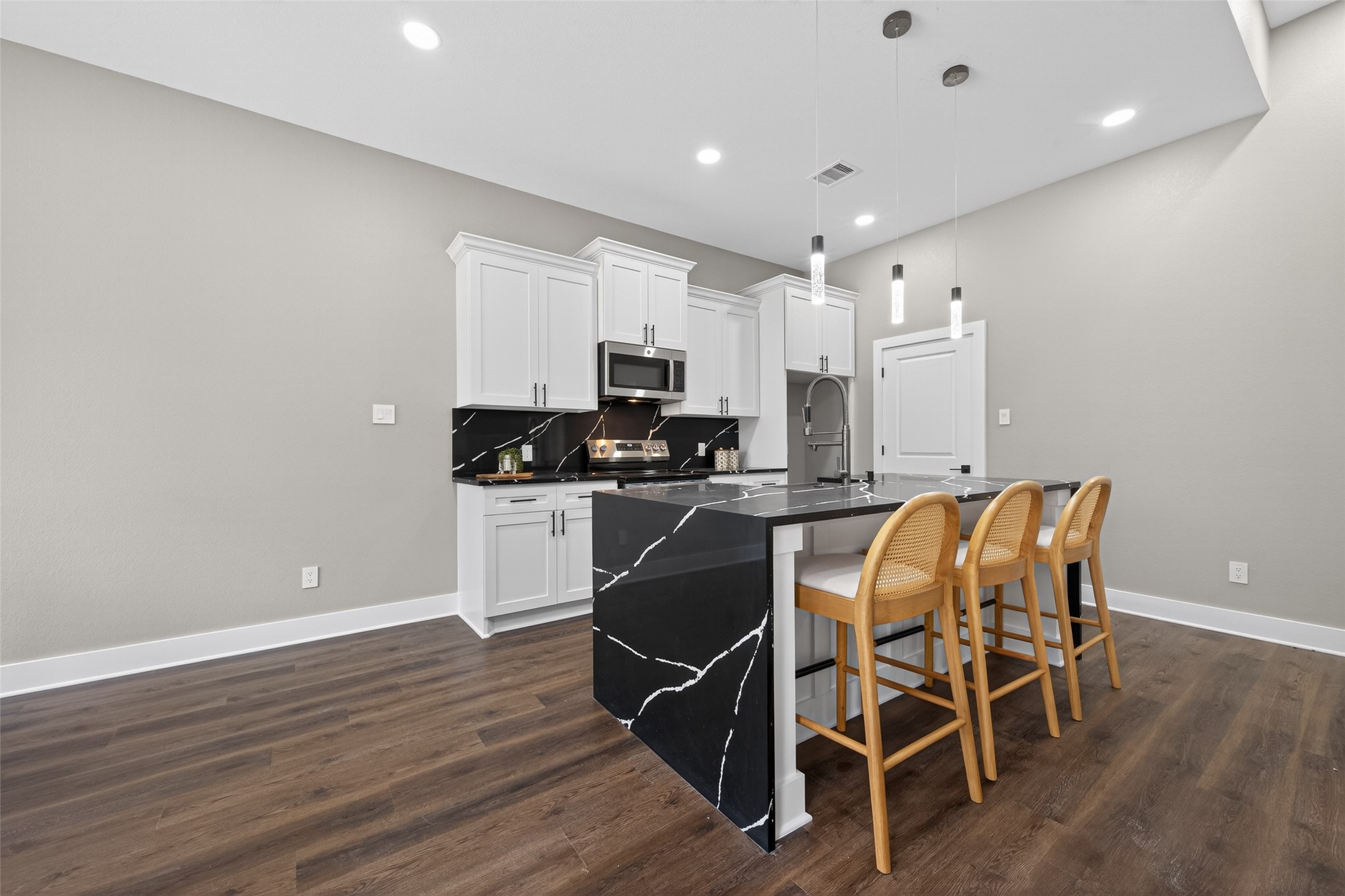 265 County Road 3376 Cleveland, TX 77327 - Photo 12 of 38 a kitchen with granite countertop a dining table chairs stainless steel appliances and cabinets