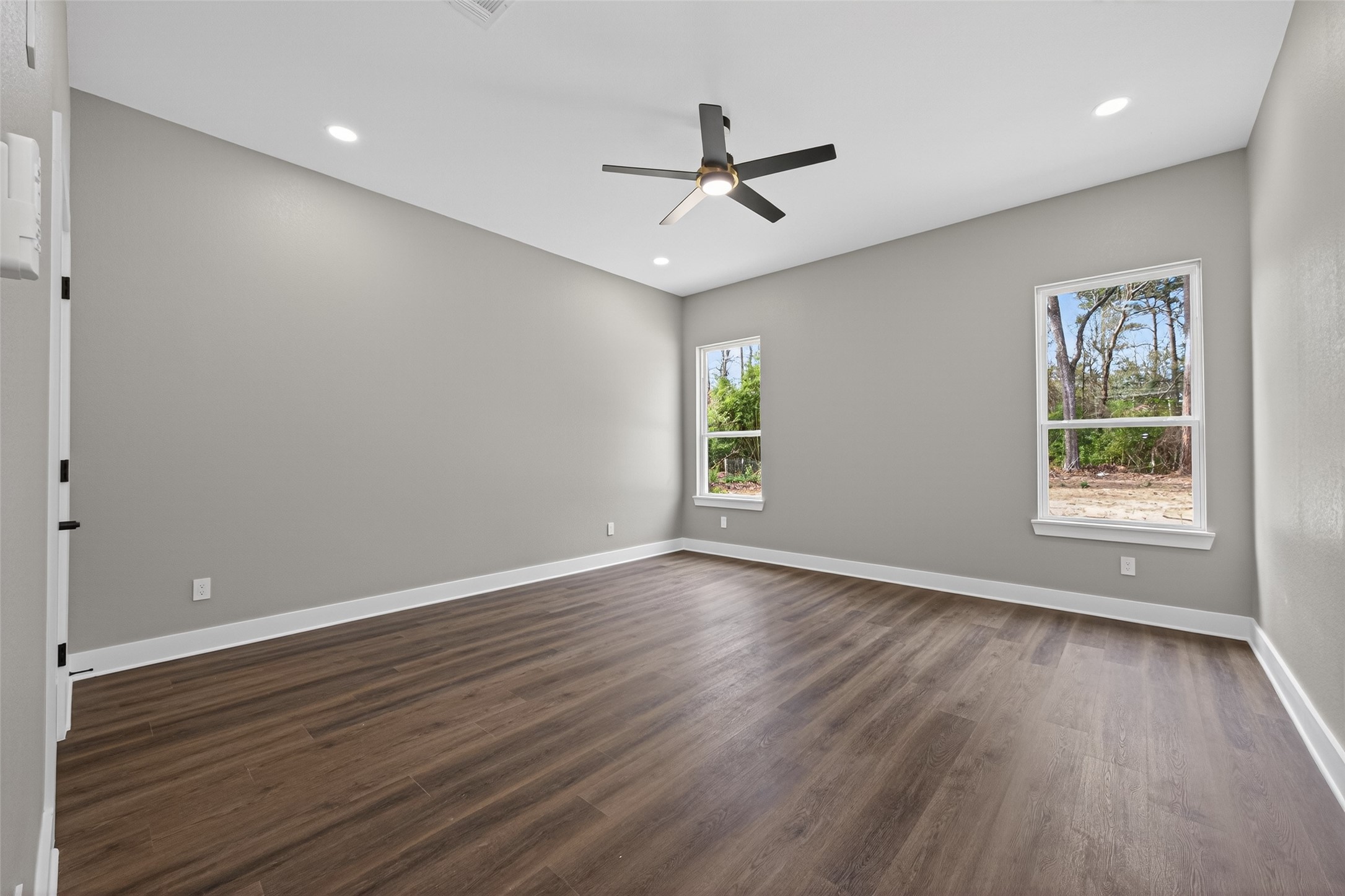 265 County Road 3376 Cleveland, TX 77327 - Photo 20 of 38 a view of an empty room with wooden floor and a window