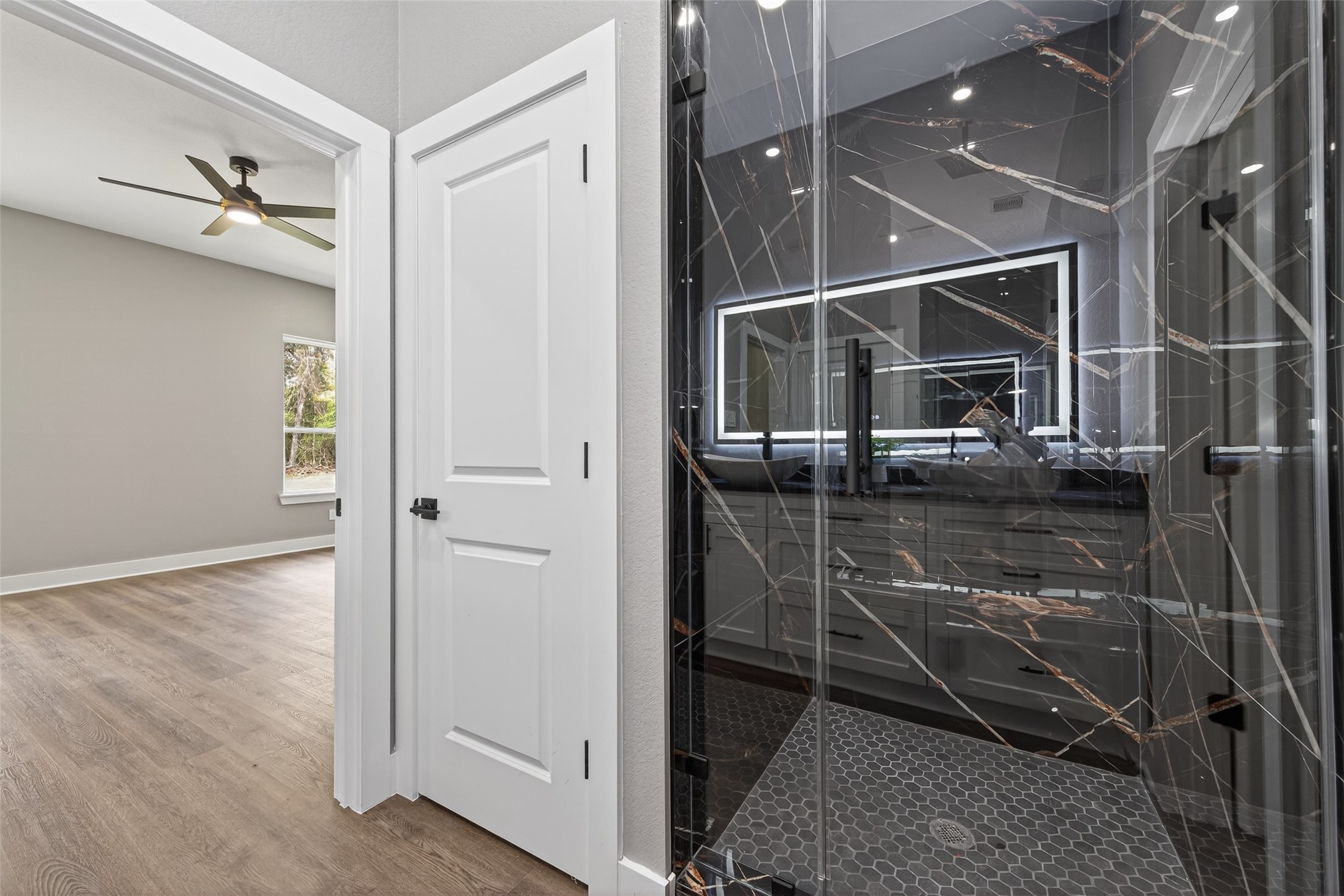 265 County Road 3376 Cleveland, TX 77327 - Photo 24 of 38 an empty room with wooden floor and bathroom