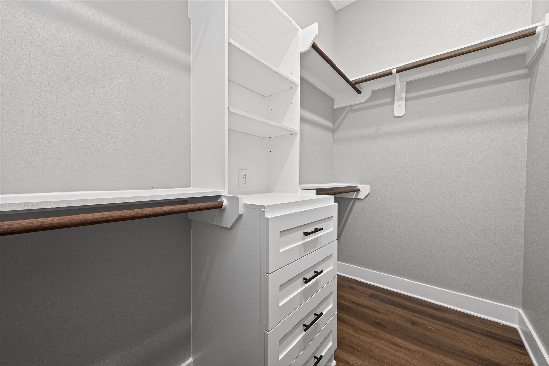 265 County Road 3376 Cleveland, TX 77327 - Photo 26 of 38 a view of walk in closet with empty racks