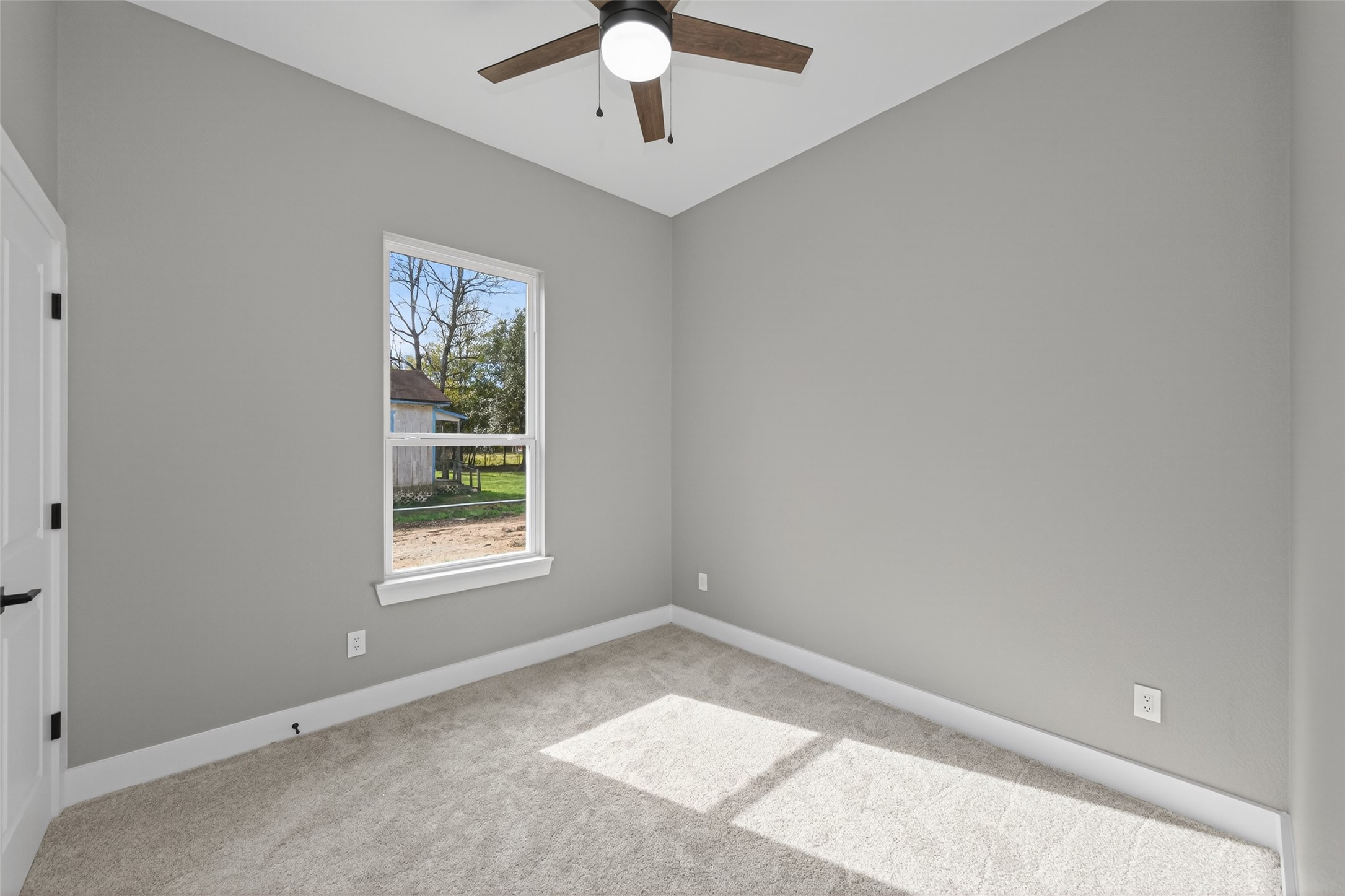 265 County Road 3376 Cleveland, TX 77327 - Photo 29 of 38 an empty room with a window