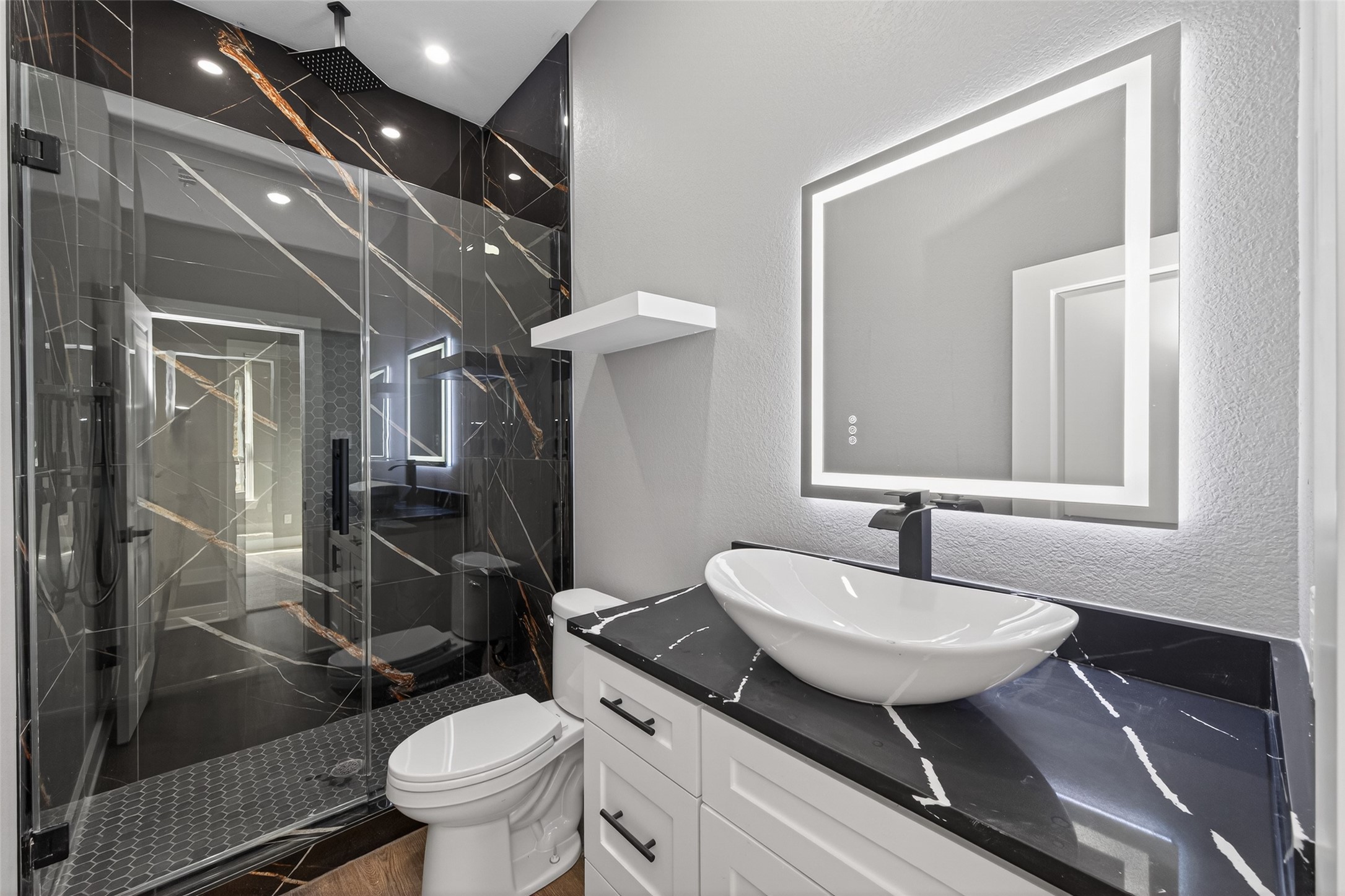 265 County Road 3376 Cleveland, TX 77327 - Photo 31 of 38 a bathroom with a sink toilet a mirror and shower