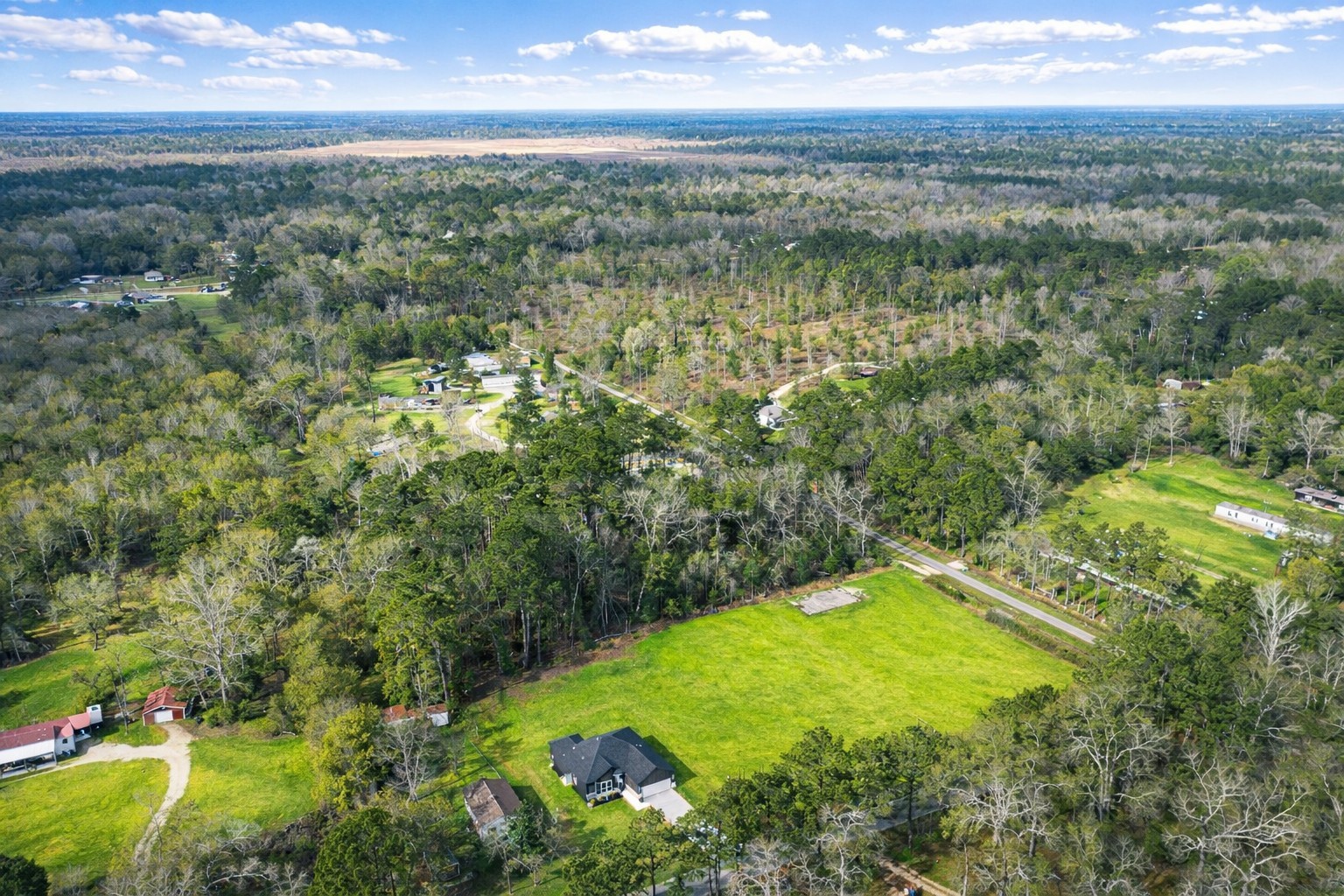 265 County Road 3376 Cleveland, TX 77327 - Photo 4 of 38 a view of a lake and a yard