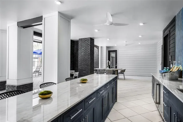 a bathroom with a granite countertop sink and a bathtub