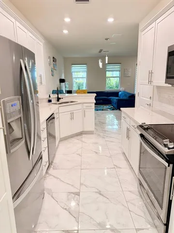 a kitchen with a sink stainless steel appliances and cabinets