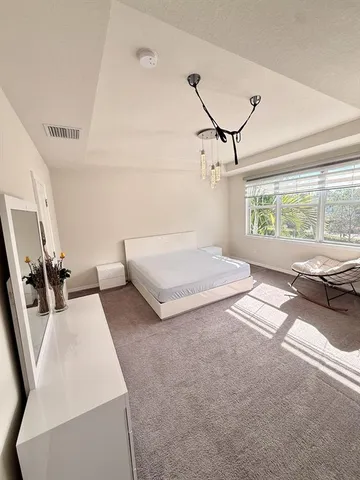 a bedroom with furniture and a window