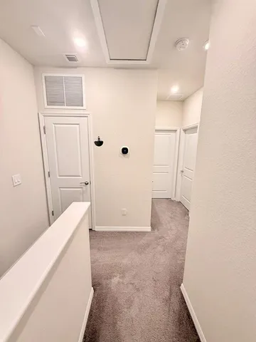 a view of hallway with white walls