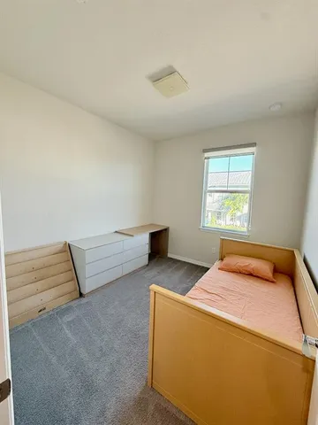 a bedroom with furniture and a window