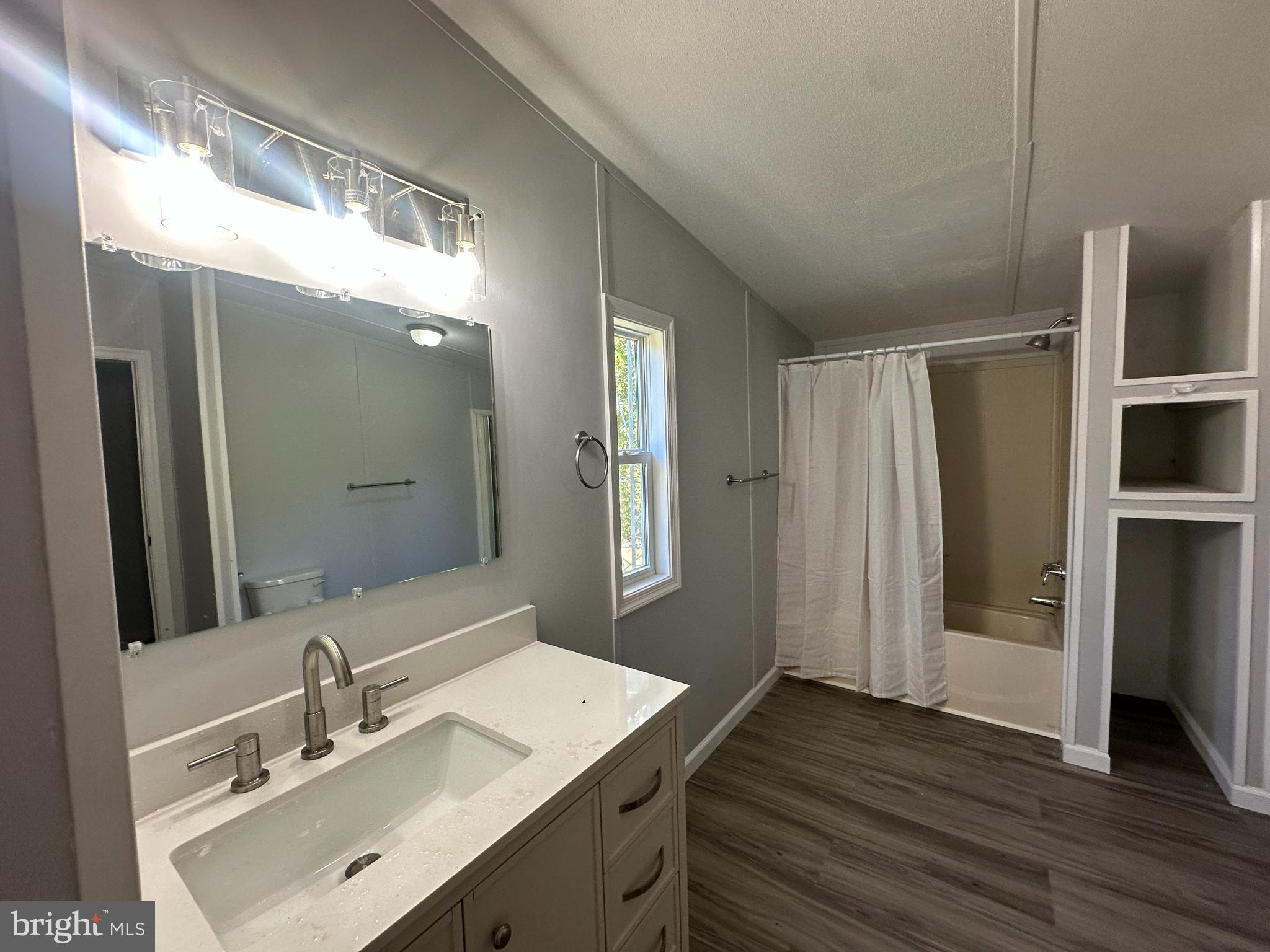 211 Maple Street Port Norris, NJ 08349 - Photo 14 of 28 a bathroom with a sink mirror and shower
