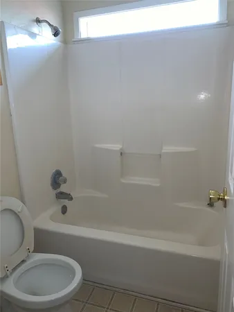 a bathroom with a toilet and bathtub