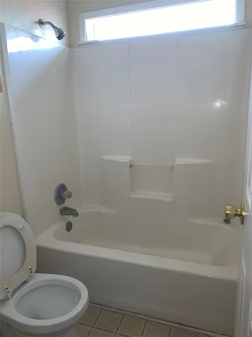 a bathroom with a toilet and bathtub