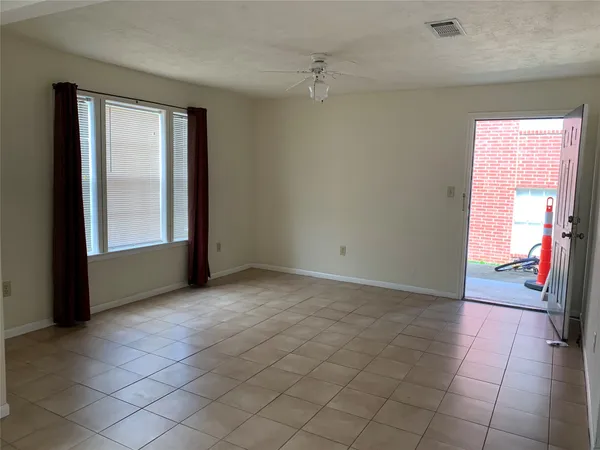an empty room with windows and closet
