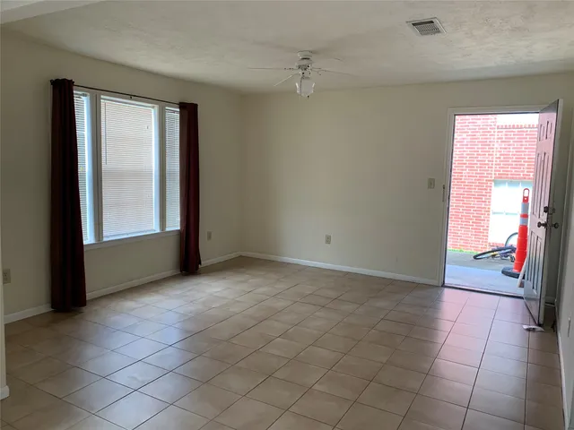 an empty room with windows and closet
