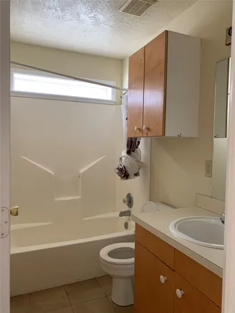 a bathroom with a sink a toilet and bathtub