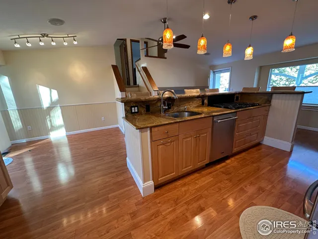 a bathroom with a granite countertop sink toilet and mirror