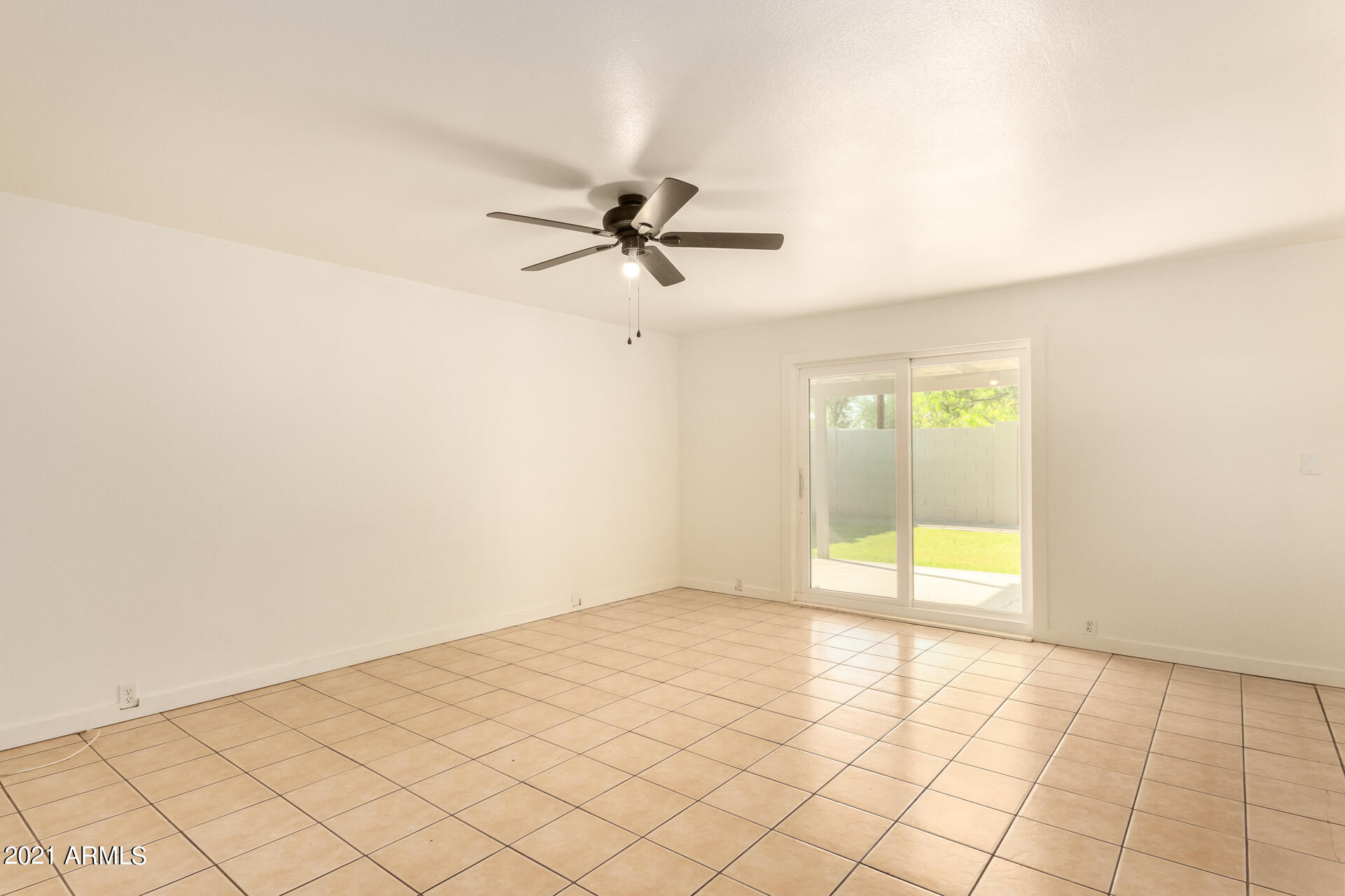 803 West Elna Rae Street Tempe, AZ 85281 - Photo 4 of 28 an empty room with a ceiling fan and carpet