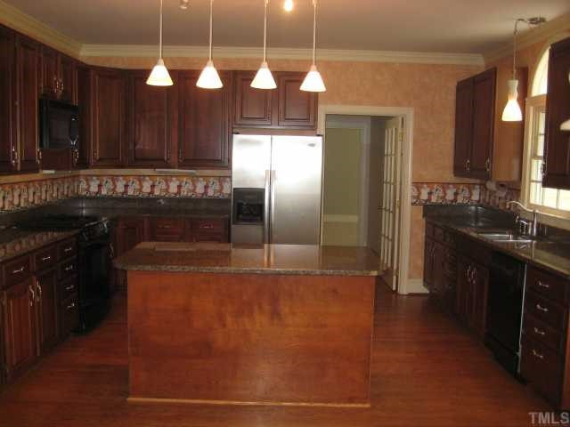 8308 Harps Mill Road Raleigh, NC 27615 - Photo 4 of 12 Fabulous kitchen with granite, Jenn-Air gas range, updated fixtures. Opens to breakfast area and sunroom. This is where everyone will gather and there's room for them all. Kitchen
